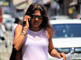 Mujer hablando por teléfono en la calle con expresión malhumorada