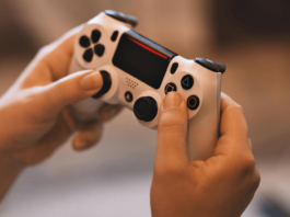manos de un joven sostienen un control de videojuegos
